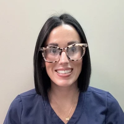 Chiropractic Vienna VA Ali Acevedo Ali Acevedo smiling in glasses.